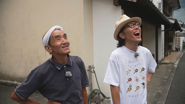 Plasterer Takeshi Ichikane shows Nagazumi around the town’s Kote-e reliefs